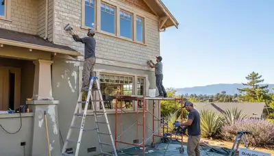 Painter sanding exterior wall for new coating during surface prep in Mountain View, CA